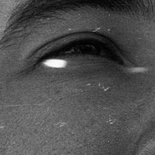 Close-up of a bearded man with facial piercings.