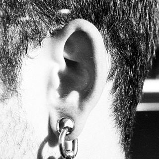Close-up of a person with ear piercing.