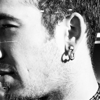 Close-up of a person with ear piercing.