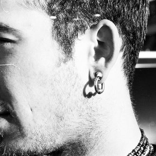 Close-up of a person with ear piercing.