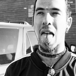 Man with tongue piercing and nose ring.