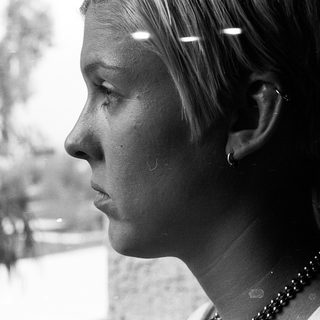 Close-up of person with tear on cheek.