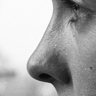 Close-up of person with tear on cheek.