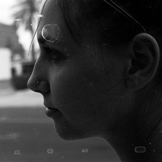Close-up of person looking out window.