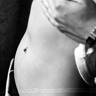 Pregnant person wearing loose clothing.