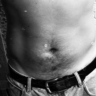 Prominent abdominal protrusion with belted trousers.