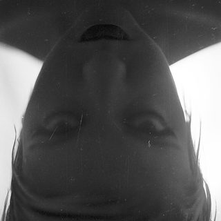 Silhouette of person with wet hair.