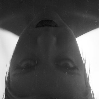 Silhouette of person with wet hair.