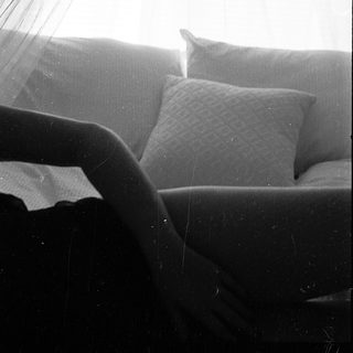 Soft bed with pillows under natural light.
