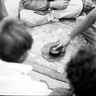 Men gathered around a map discussing plans.
