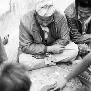 Men gathered around a map discussing plans.