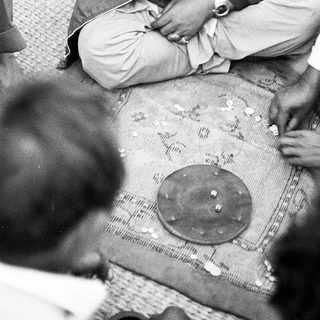 Traditional Indian card game session among men.