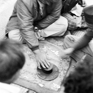 People playing traditional board game together.