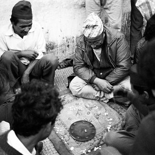 Group of people gathered for traditional foot massage session.