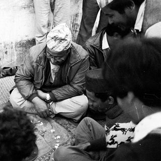 Group meeting with elderly man speaking to gathered people.