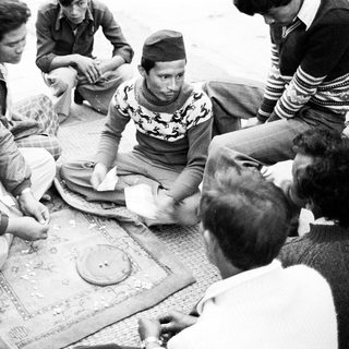 Group playing traditional board game together.