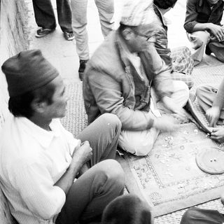 People playing traditional board game outdoors.