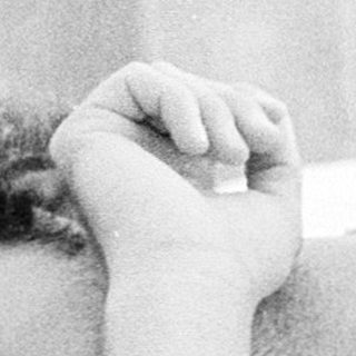 Man resting or sleeping on a bed.