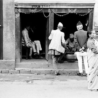 Traditional gathering outside a Nepalese home entrance.