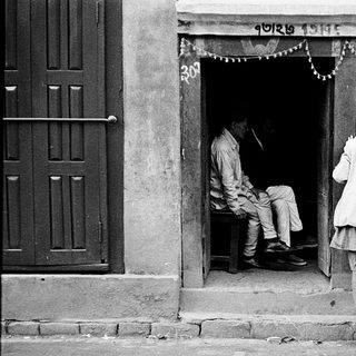 Traditional gathering outside a Nepalese home entrance.