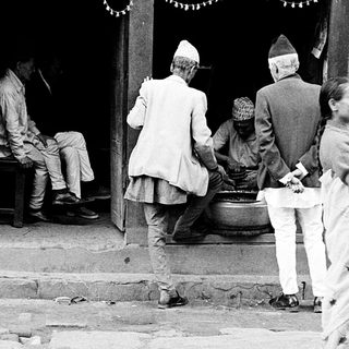 Traditional gathering outside a Nepalese home entrance.