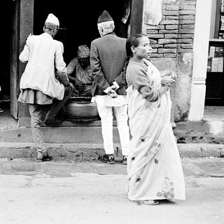Traditional gathering outside a Nepalese home entrance.