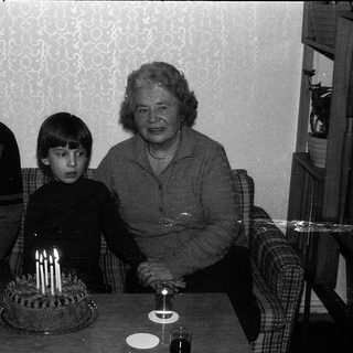 Family celebrating a birthday with cake.