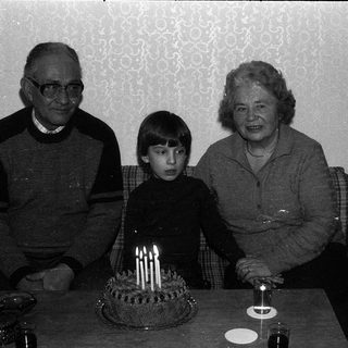 Family celebrating a birthday with cake.