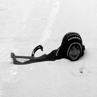Camera partially buried in snow.