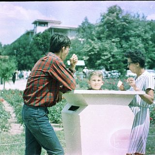 People enjoying food outdoors in a park setting.