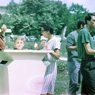 People enjoying food outdoors in a park setting.