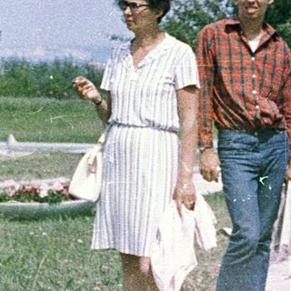 Family walking outdoors in a park.