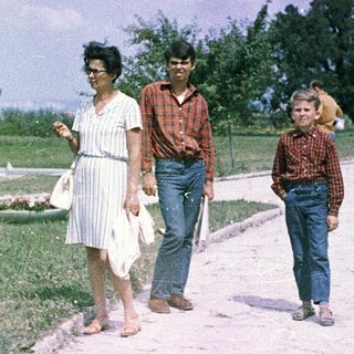 Family walking outdoors in a park.