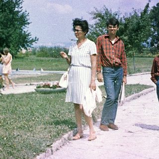 Family walking outdoors in a park.