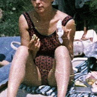 Family beach outing in vintage swimwear.
