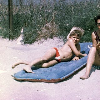 Family beach outing in vintage swimwear.