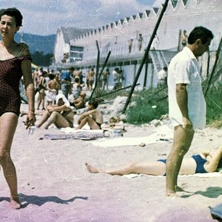 Family beach scene from mid-20th century.