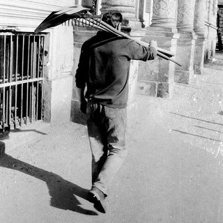 Man holding umbrella, walking with dynamic pose.