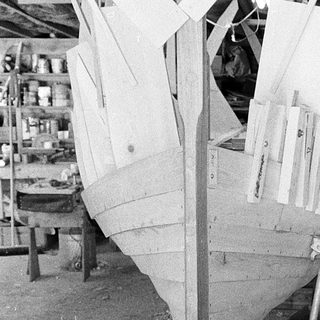 Traditional wooden boat under construction on keel.