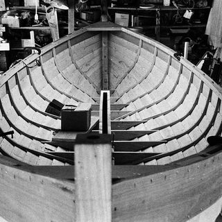 Boat hull under construction using planking.