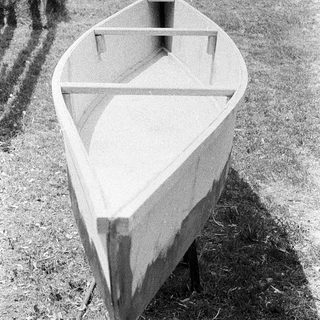 Empty wooden boat on dry land.