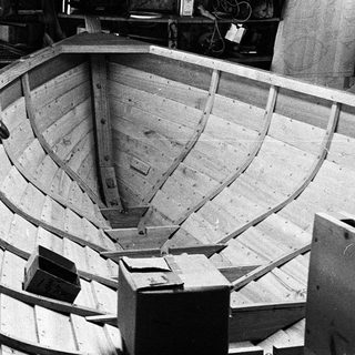 Boat hull under construction with wooden frames.