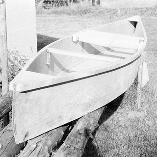 Small wooden boat resting on supports.
