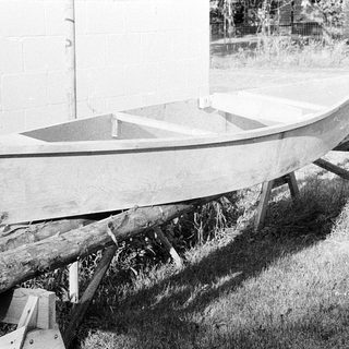 Small wooden boat on temporary supports.