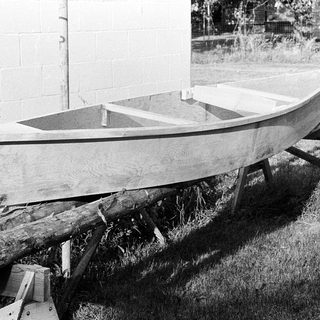 Small wooden boat resting on supports.