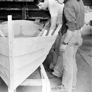 Boat frame under construction in workshop.