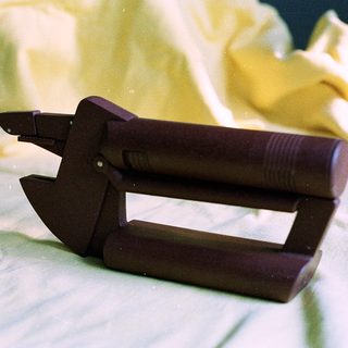 Wooden chocolate mold with press handles.