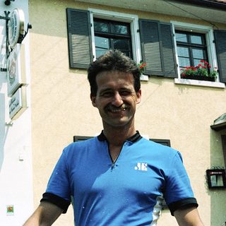 Man smiling outside a residential building.