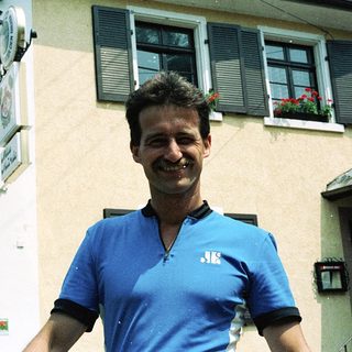 Man smiling outside a residential building.