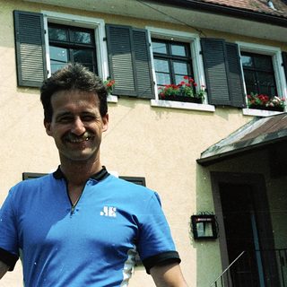 Man smiling outside a residential building.